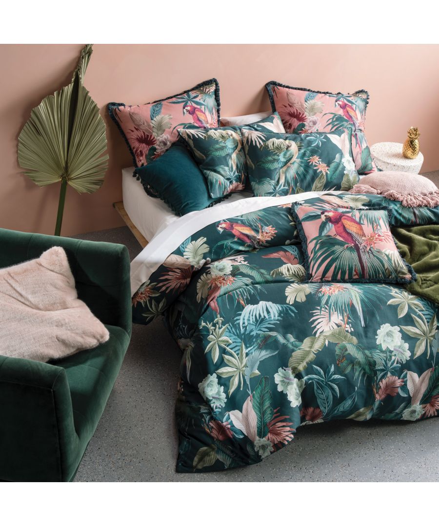Linen House Fernanda double duvet cover set features a vibrant tropical floral design in greens, pinks, and whites, complemented by plush cushions and a cozy green throw.
