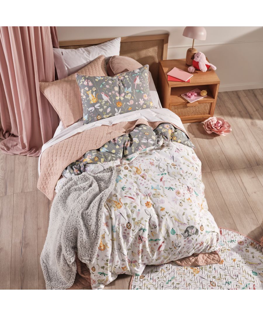 Multicolour cotton duvet cover set featuring a floral garden design, complemented by a grey pillowcase and a textured pink quilt in a cozy bedroom setting.