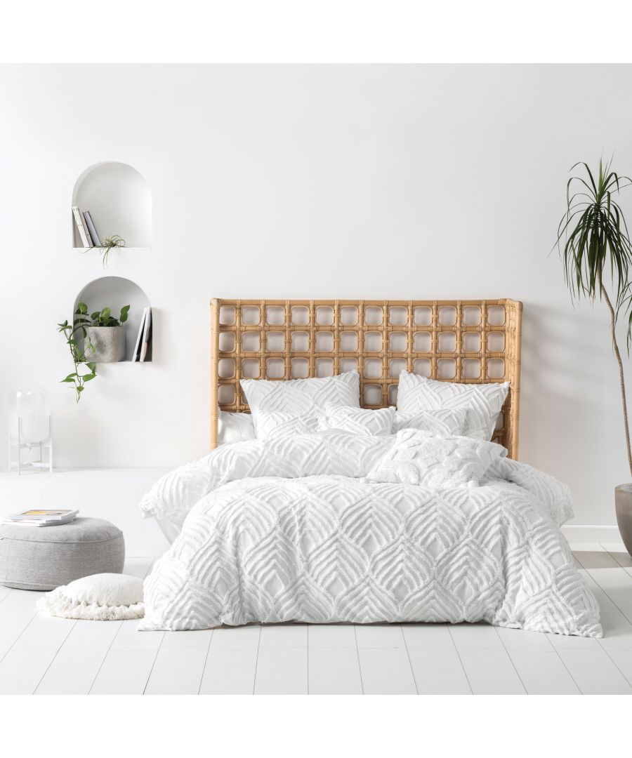 Linen House Palm Springs duvet set in multicolour features a textured white design, complemented by matching pillowcases, styled on a bed with a rattan headboard and minimalist decor.