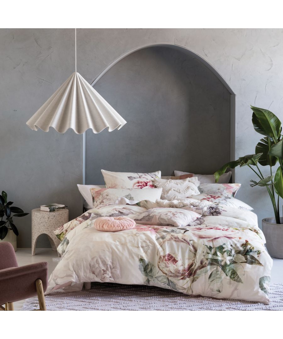 Multicolour Linen House Sansa Duvet Set in Super King size features floral patterns on a soft fabric, complemented by decorative pillows and a stylish lamp in a modern bedroom setting.
