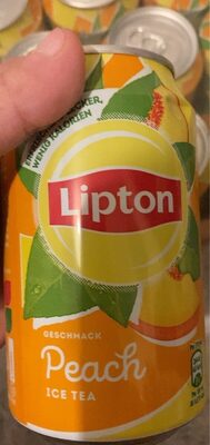 Bright orange can featuring Lipton branding, labeled "Peach Ice Tea," adorned with peach and green leaf graphics, held in a hand with multiple cans visible in the background.