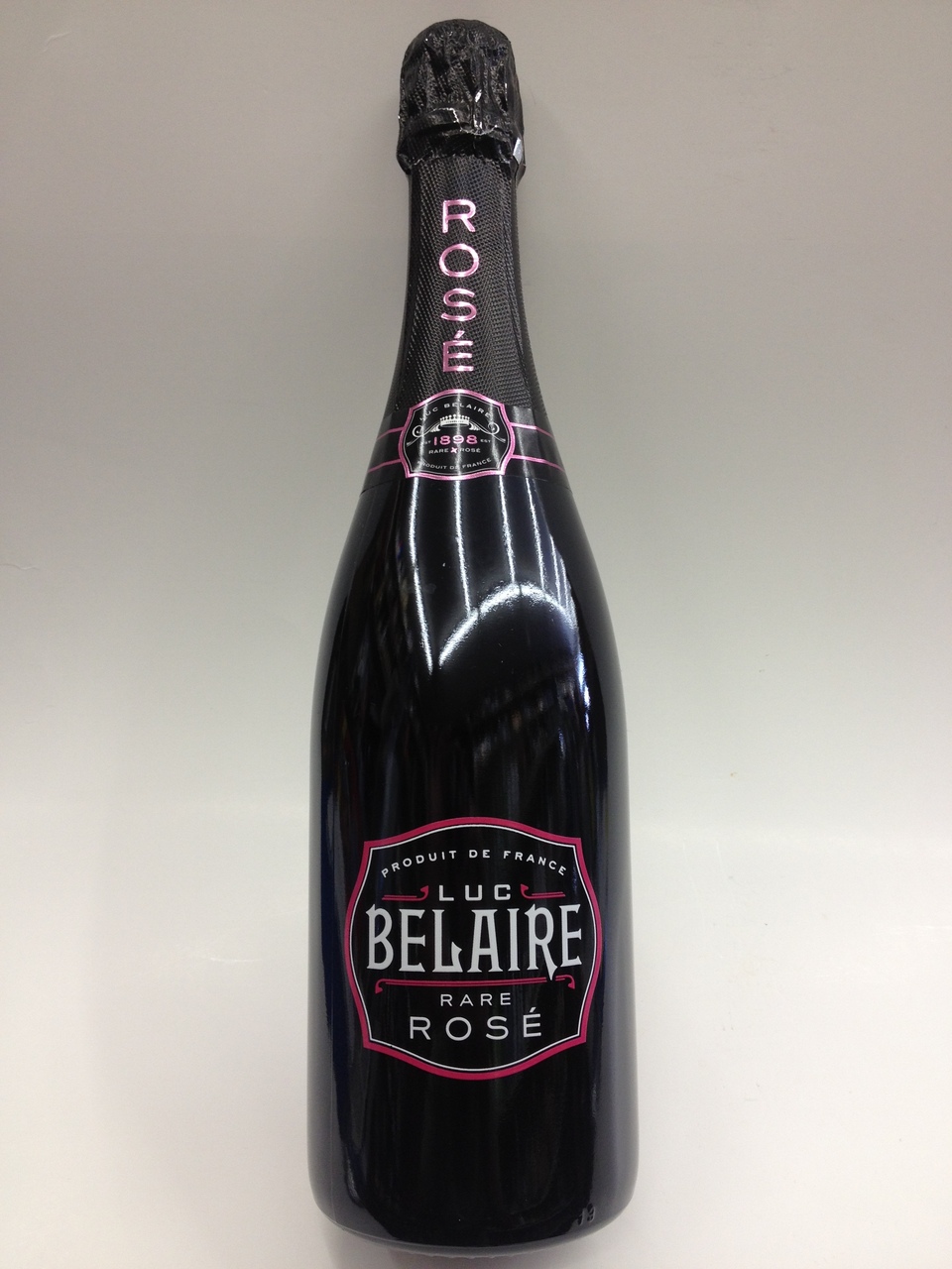 A sleek black bottle of Luc Belaire Rosé champagne with a pink label and foil, featuring elegant typography and a glossy finish.