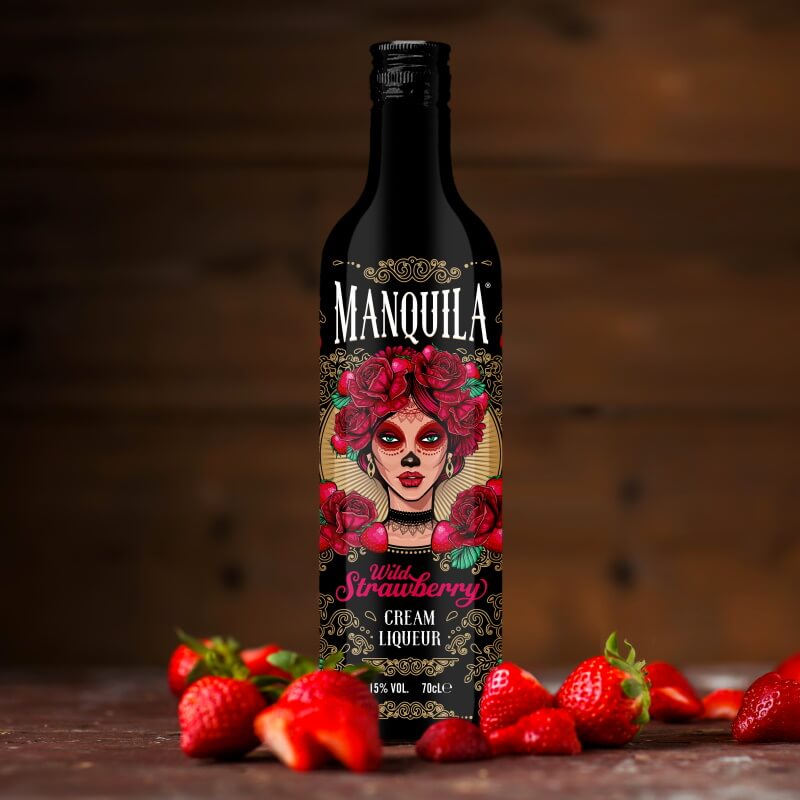 Black bottle of Manquila Wild Strawberry Cream Liqueur, featuring a vibrant label with a woman adorned in flowers, surrounded by fresh strawberries on a wooden surface.