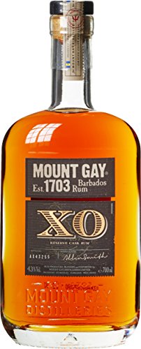 Clear glass bottle of Mount Gay XO Rum, featuring a rich amber color, a cork stopper, and a black label with gold accents, showcasing "Mount Gay" and "XO" prominently.