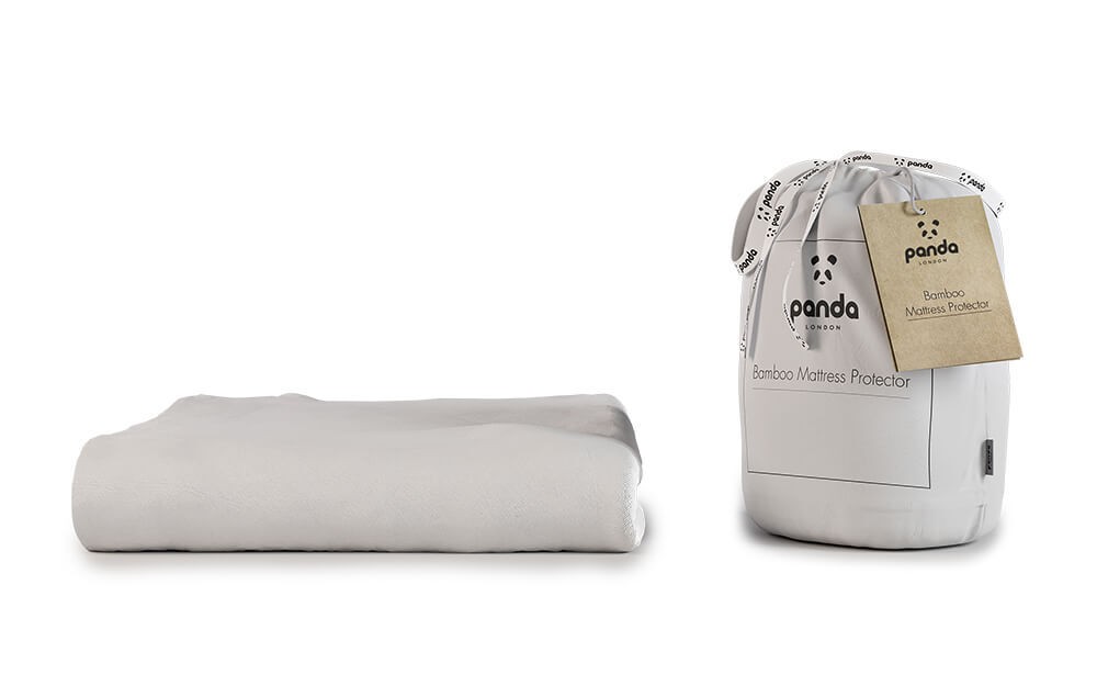 Light grey bamboo mattress protector folded beside a cylindrical packaging with a white label and a decorative tag, featuring the Panda logo.