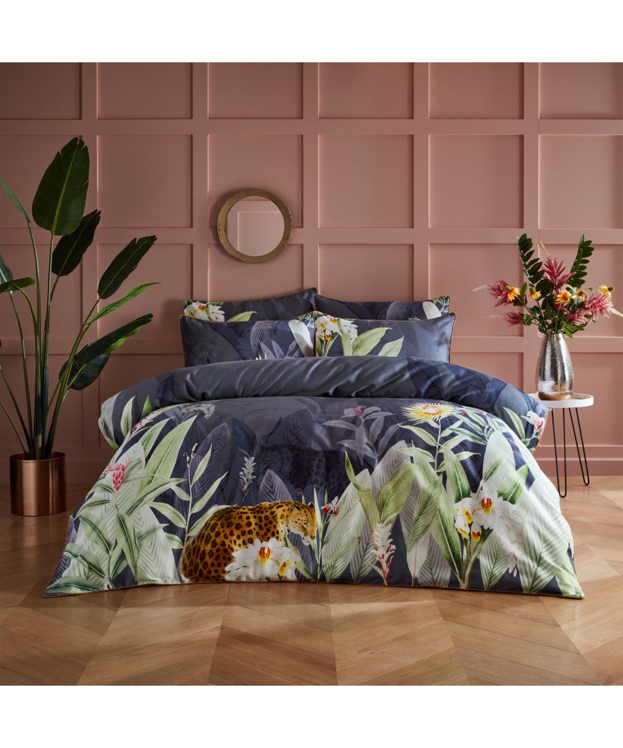 Multicolour cotton duvet cover set featuring a luxurious leopard print and botanical design, with vibrant greens, blues, and yellows, suitable for a king-size bed.