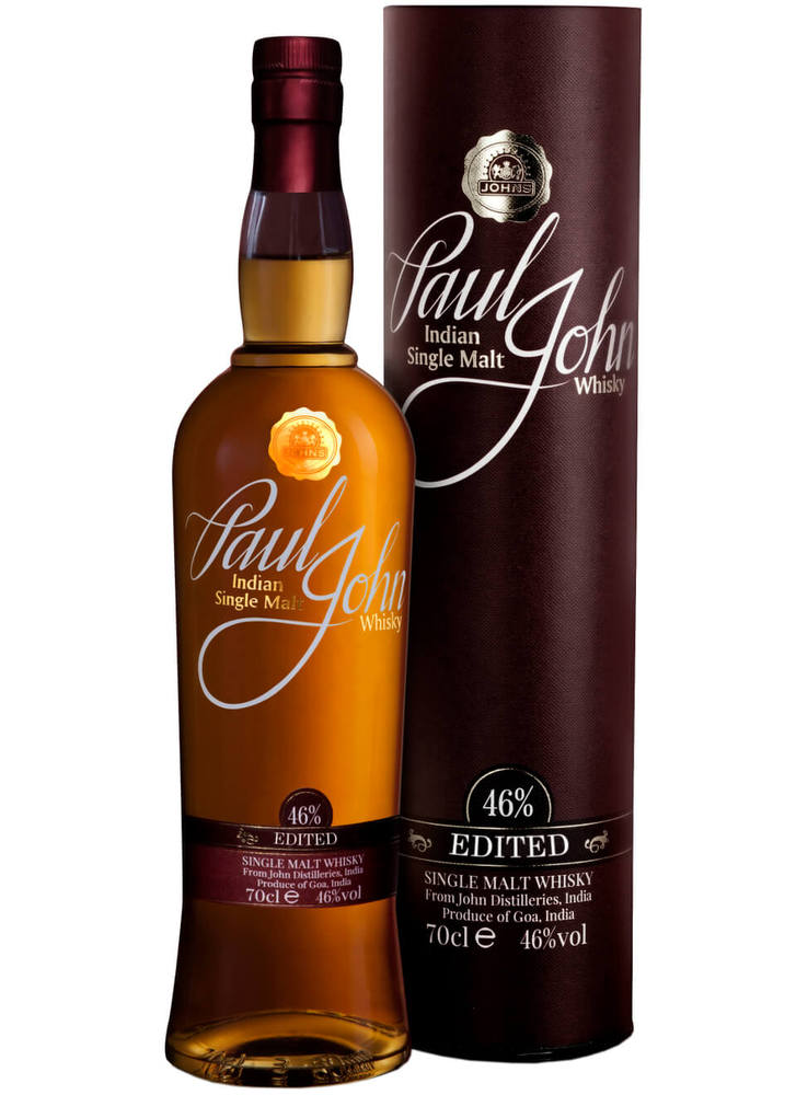 Amber bottle of Paul John Edited Indian Single Malt Whisky, 70 Cl, with a dark brown cylindrical tube, featuring gold accents and a label displaying the brand name and alcohol content.