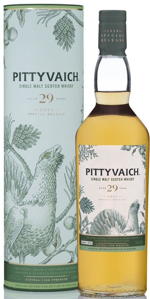 Pittyvaich 29 Year Old whisky in a clear glass bottle with a light amber liquid, featuring a decorative green and white cardboard tube with intricate illustrations of birds and foliage.