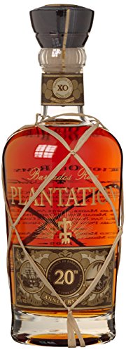 Planteray XO Rum bottle with a decorative woven ribbon, featuring a clear glass design, rich amber liquid, and a cork stopper, accompanied by a tulip glass.