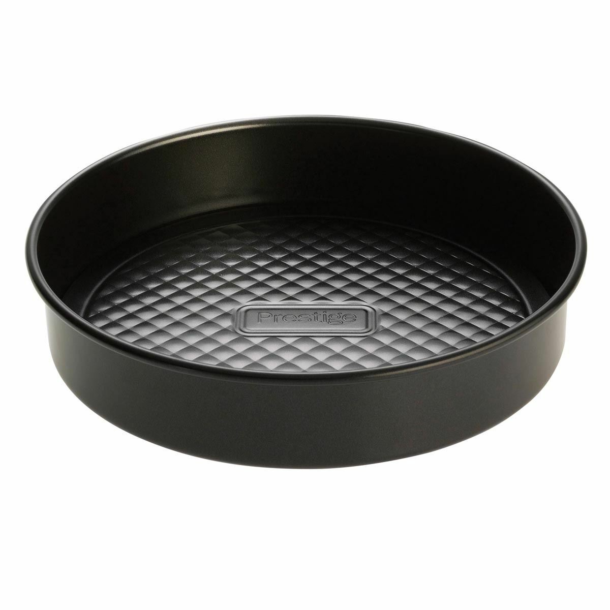 Round, non-stick sandwich tin by Prestige, measuring 7 inches, features a loose base and a textured diamond pattern inside, finished in a sleek black color.