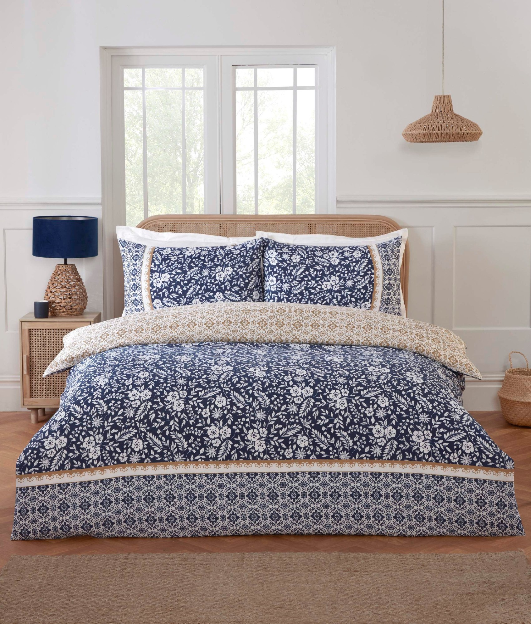 Eleanor Floral Geometric reversible duvet cover set features a navy blue floral pattern on one side and a cream geometric design on the other, complemented by matching pillowcases.