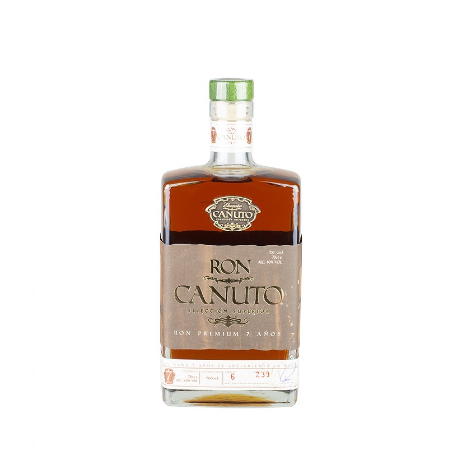 Amber-colored bottle of Ron Canuto 7 Year Old Rum, featuring a green cap, a label with gold and brown accents, and the text "RON CANUTO" prominently displayed.