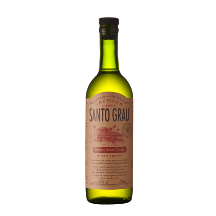 Green glass bottle of Santo Grau Coronel Xavier Chaves Cachaca, featuring a beige label with red text and a tropical scene, containing 70 cl of spirit at 40% alcohol by volume.