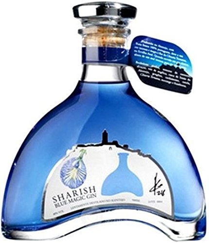 A curved glass bottle of Sharish Blue Magic Gin, featuring a vibrant blue hue, a cork stopper, and a label with a floral design and silhouette of a tower.