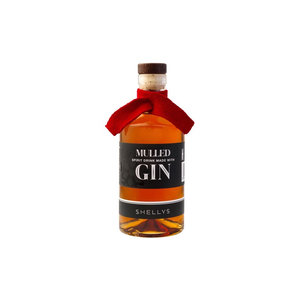 A clear glass bottle of Shelly's Mulled Gin Liqueur, featuring a cork stopper, a red felt ribbon around the neck, and a black label with white text.