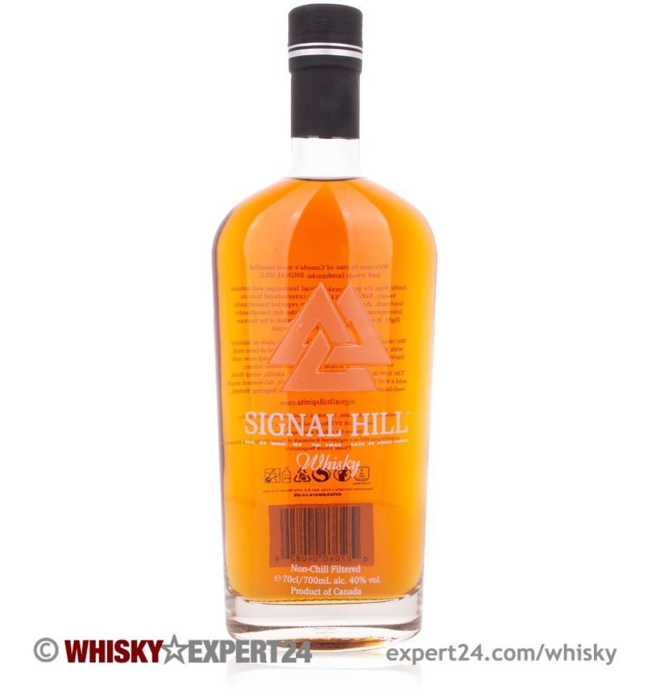 Clear glass bottle of Signal Hill Canadian Whisky, featuring a distinctive triangular logo, orange-tinted liquid, and a black cap, with detailed labeling on the back.