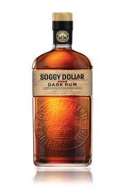 Amber-colored glass bottle of Soggy Dollar Dark Rum, 70 cl, featuring a textured logo and gold label with black text.
