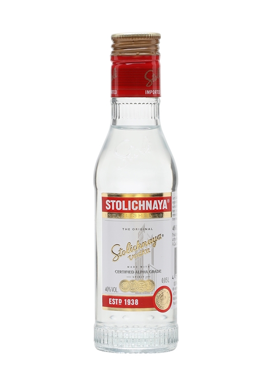 Clear glass miniature bottle of Stolichnaya Vodka, 5 cl, featuring a red and gold label with "STOLICHNAYA" prominently displayed and a cork-like cap.