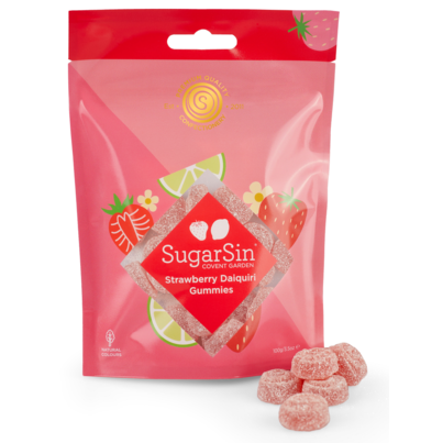 Bright pink packaging featuring strawberries and lime slices, labeled "SugarSin Strawberry Daiquiri Gummies, 100 G," with several red gummy candies in front.