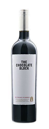 A tall, dark red wine bottle with a sleek design, featuring a white label that reads "THE CHOCOLATE BLOCK" in bold black letters, topped with a silver cap.