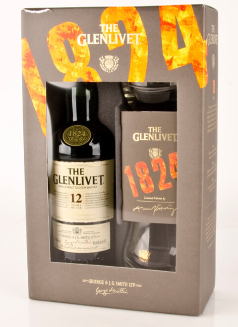 The Glenlivet 12 Year Old Single Malt Scotch Whisky gift pack features a dark green bottle with a cream label, two branded glasses, and a stylish black box with orange accents.
