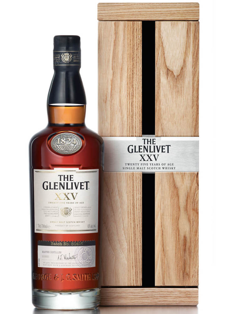 The Glenlivet XXV 25 Year Old Whisky in a tall, dark glass bottle with a cork stopper, featuring a rich amber color, accompanied by a wooden box with a silver label.