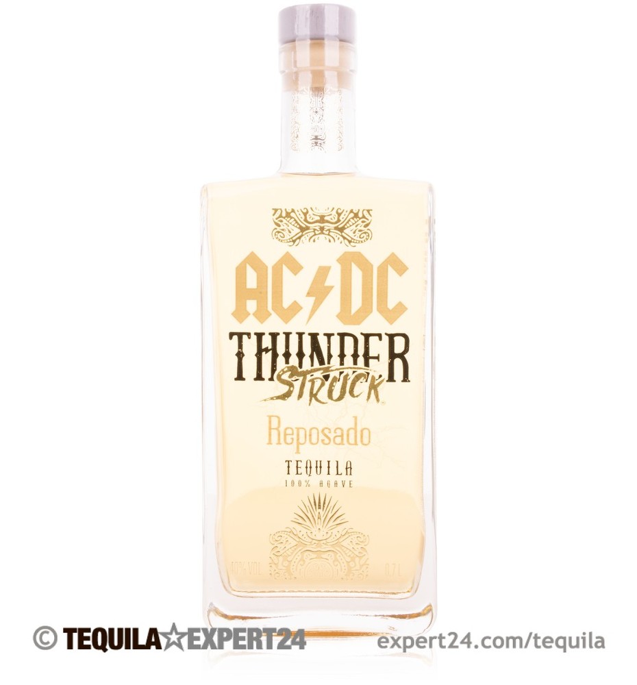Clear glass bottle of Thunderstruck Reposado Tequila by AC/DC, featuring a gold label with bold black text, showcasing a light amber liquid inside.