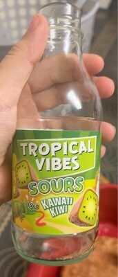 Clear glass bottle labeled "Tropical Vibes Sours Kawaii Kiwi," featuring a vibrant green label with kiwi illustrations, held in a hand against a blurred background.