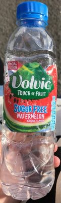 Clear plastic bottle with a blue cap, featuring a vibrant label with red and green colors, displaying "Volvic Touch of Fruit Sugar Free Watermelon" in bold text.