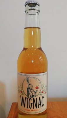 Clear glass bottle of Wignac Cidre Blanc, featuring a white label with a rabbit illustration, filled with light golden cider, capped with a silver crown cap.