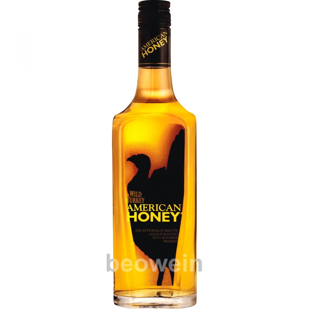 Clear glass bottle of Wild Turkey American Honey Liqueur, featuring a golden amber liquid, black label with yellow text, and a silhouette of a turkey.