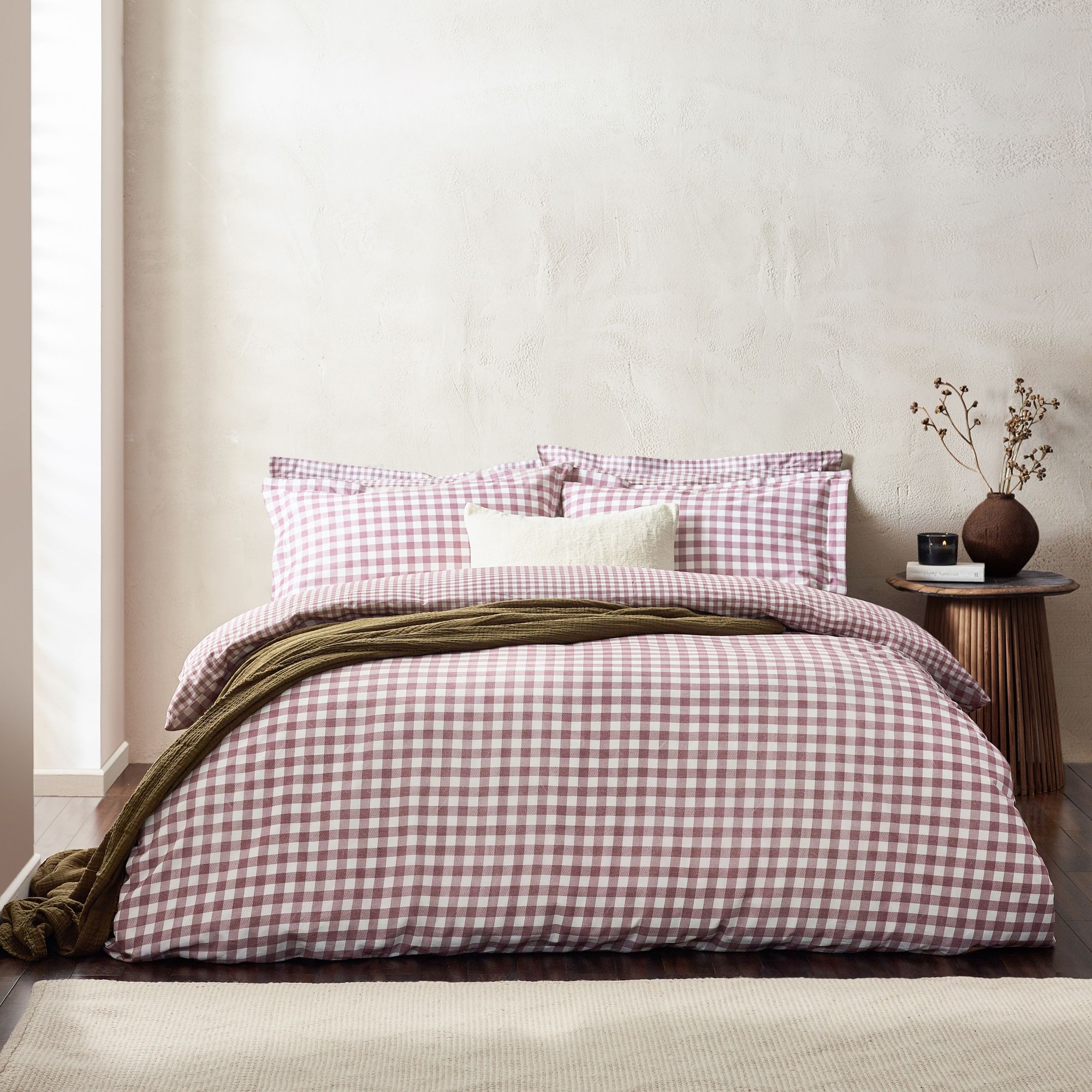 Berry check patterned 100% cotton duvet cover set in super king size, featuring matching pillowcases and a textured olive green throw draped over the bed.