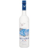 Grey Goose Vodka bottle with frosted glass, blue cap, and flying geese design above a mountain and water scene.