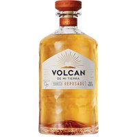 Volcan Reposado Tequila 70cl bottle with amber liquid, wooden cap, and white label featuring a sunburst design.