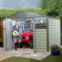 Green and gray metal shed with double doors, sloped roof, and interior shelves, housing a red lawn tractor.