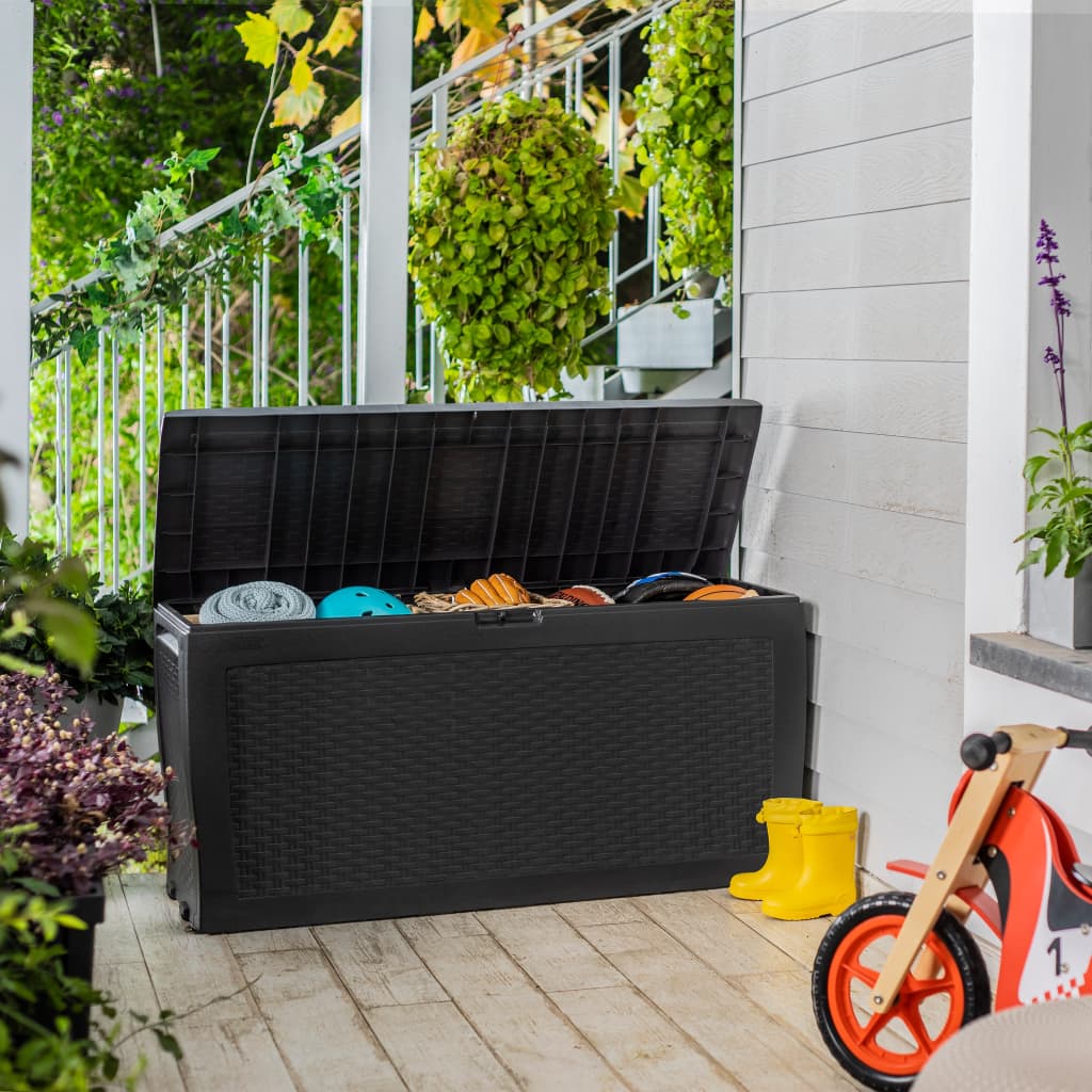 Anthracite-colored Keter Samoa plastic garden storage box, measuring 3'10" x 1'6", features a textured design and a spacious interior for outdoor storage, placed on a wooden deck.