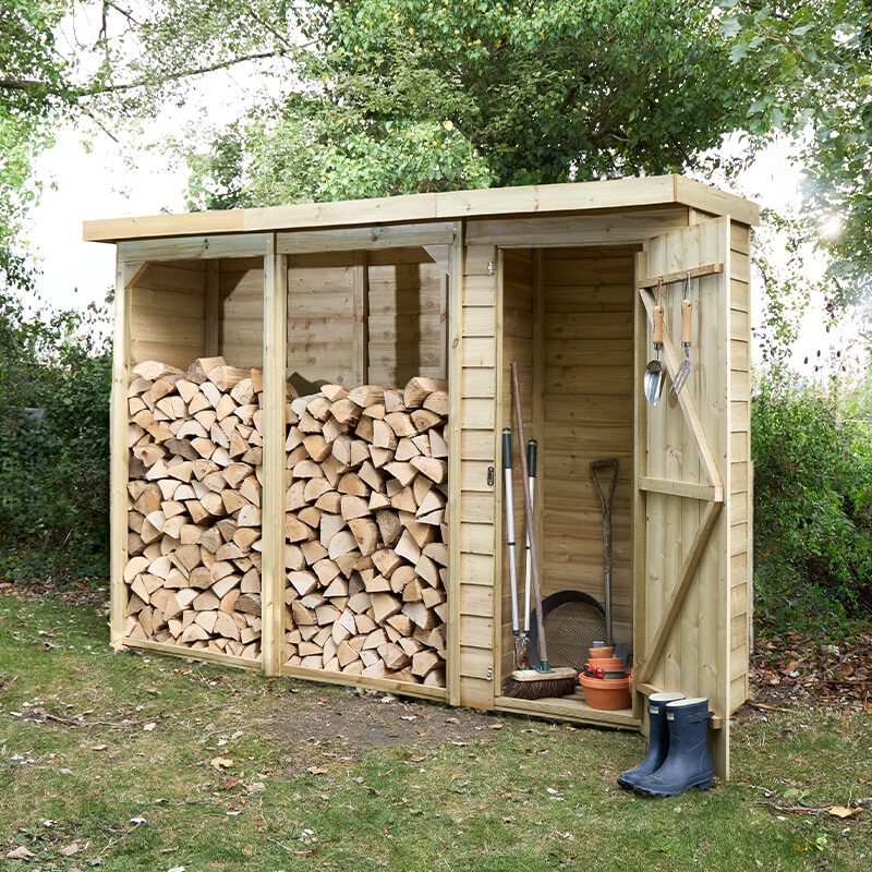 Large wooden logstore in natural finish, featuring two spacious compartments for firewood and tool storage, with a sloped roof and open front for easy access.
