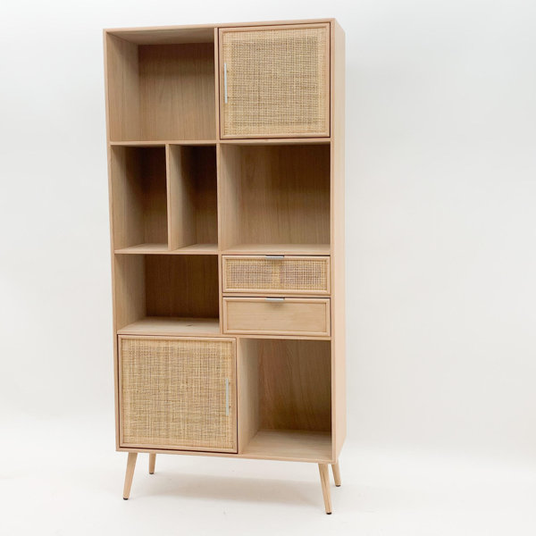Tall wooden display cabinet in light acacia finish, featuring open shelves, two woven rattan doors, and a small drawer, supported by tapered legs.