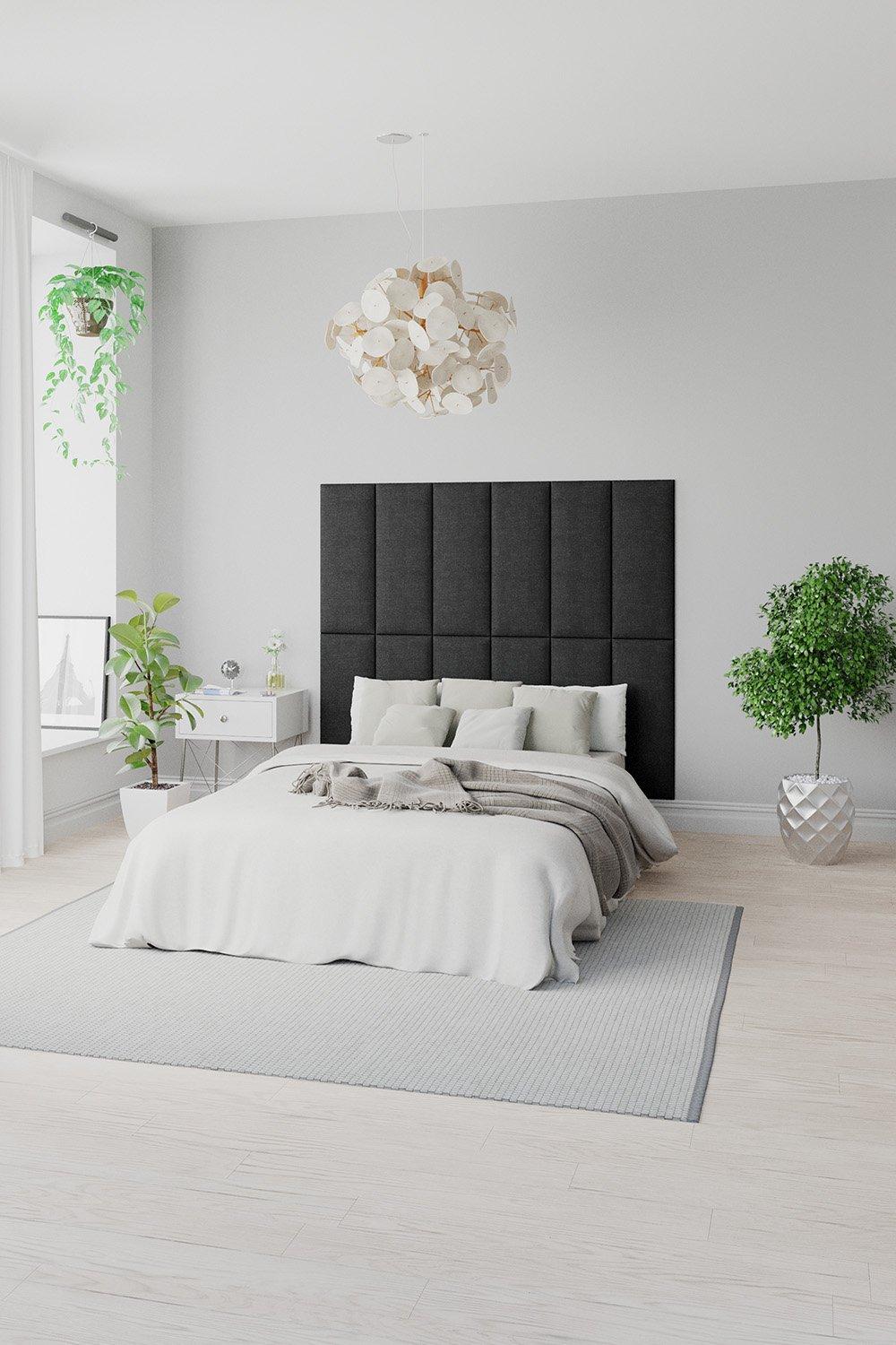 Four modular upholstered panels in slate grey Malham weave fabric, forming a stylish wall-mounted headboard, set against a light grey wall in a modern bedroom.