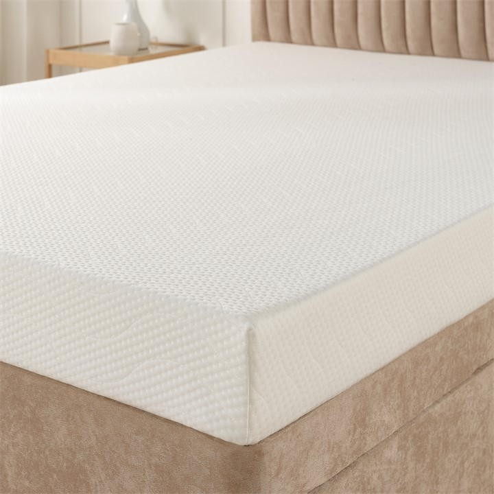 White eco foam mattress with a textured surface, measuring 10cm thick, placed on a beige upholstered bed base, suitable for a small single size.