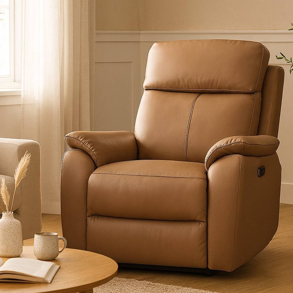 Tan real leather power recliner armchair with plush cushioning, sleek design, and a side button for reclining, set in a cozy room with natural light.