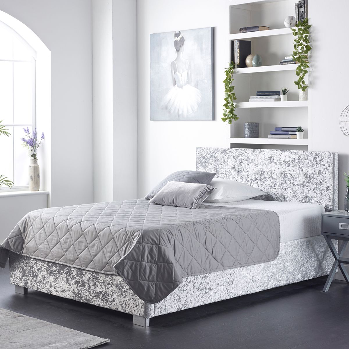 Aspire Ottoman Storage Bed in double size features a stylish grey upholstered design with a textured finish, offering hidden storage beneath the mattress and complemented by decorative pillows.