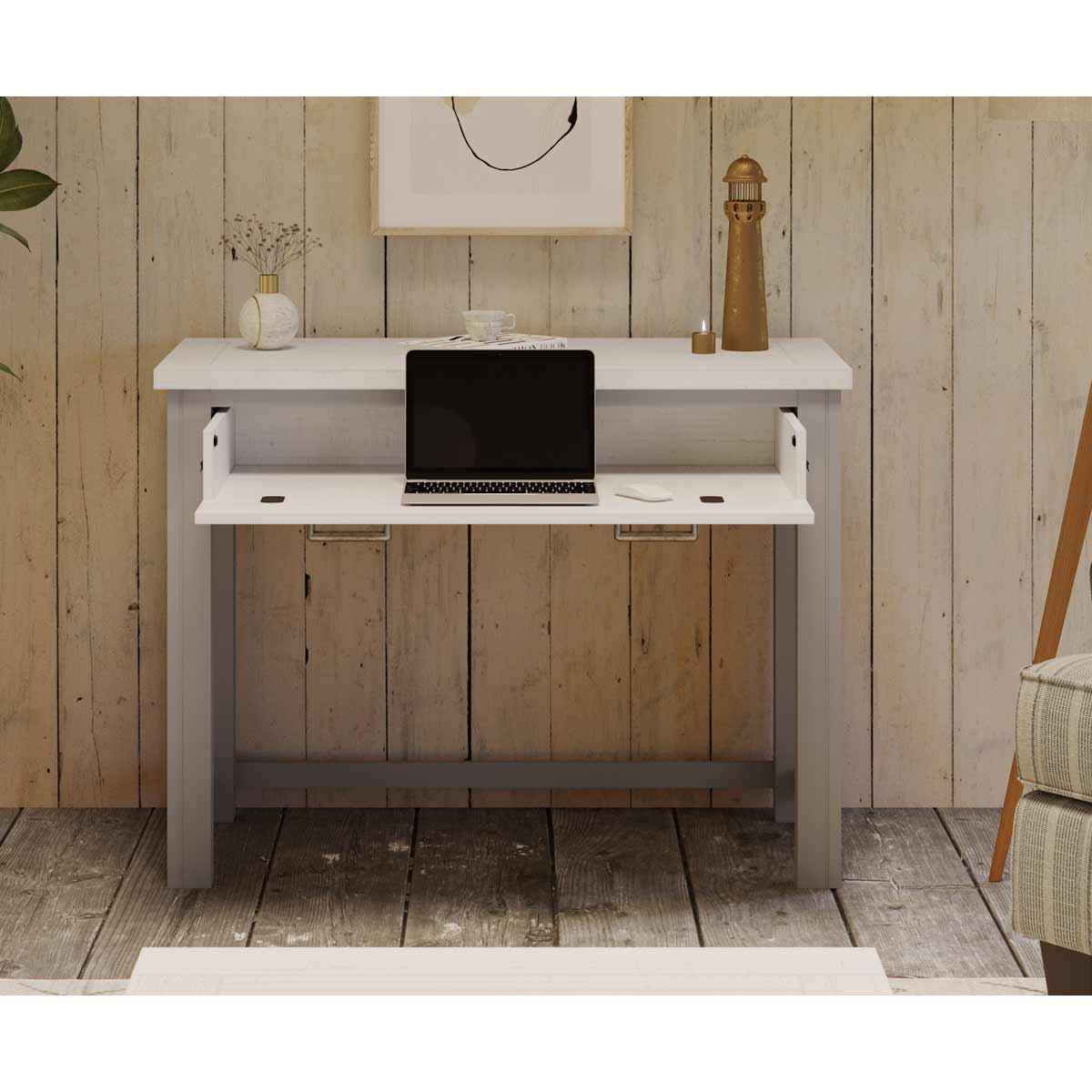 Grey wooden desk with a sleek design, featuring a hidden spacesaver mechanism, two side drawers, and a laptop on top, set against a rustic wooden wall.