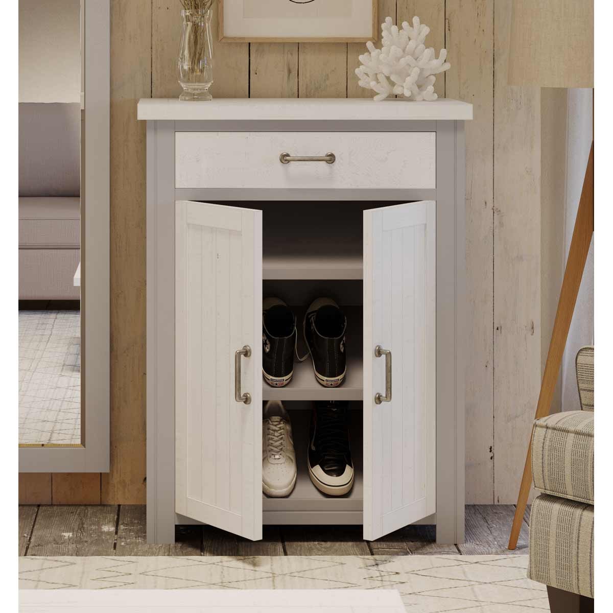 Grey shoe storage cupboard with a white top, featuring a single drawer and two doors, revealing space for shoes; made from wood with a modern design.
