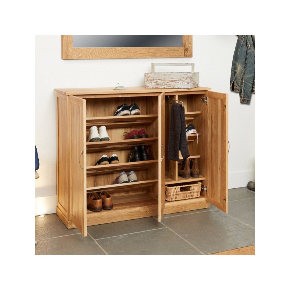 Brown oak extra-large shoe cupboard with two doors, multiple shelves, and a wicker basket, showcasing a variety of shoes neatly organized inside.