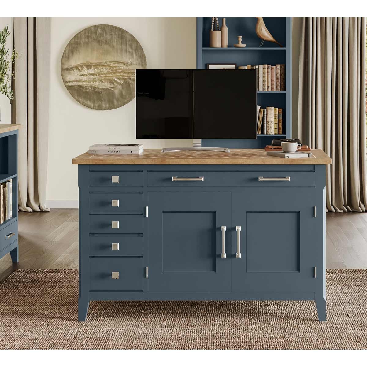 Cobalt blue hidden home office desk with a natural wood top, featuring multiple drawers, cabinet doors, and modern metal handles, set in a stylish room with bookshelves.
