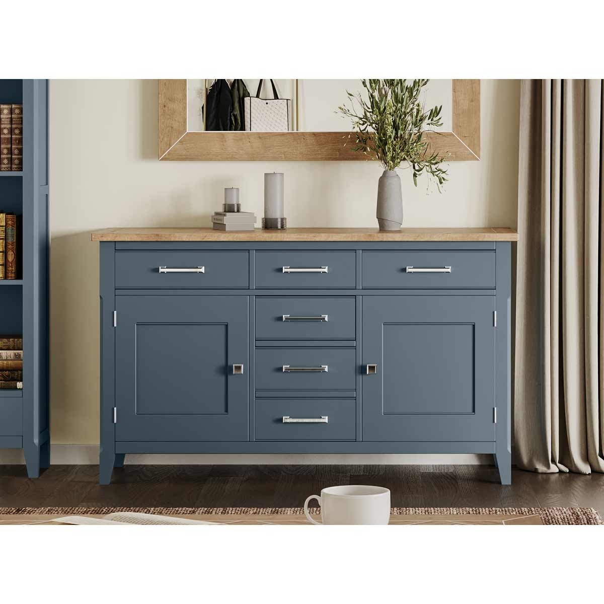 Large sideboard in cobalt blue with a natural wood top, featuring six drawers and two cabinet doors, complemented by sleek silver handles and a minimalist design.