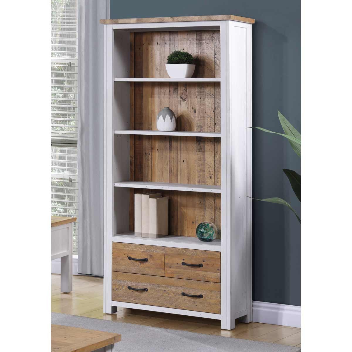 Large open bookcase in white with a natural wood top, featuring five shelves, two drawers with rustic handles, and a back panel of reclaimed wood for a stylish, modern look.