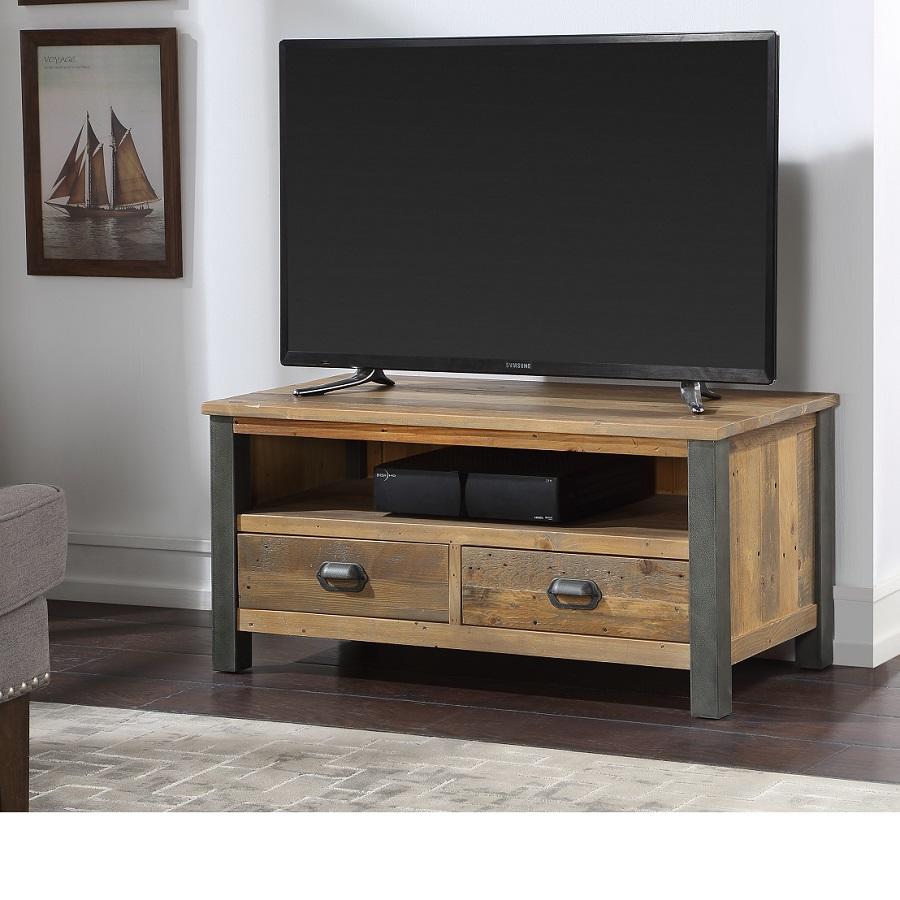 Reclaimed brown wood TV cabinet with a rustic finish, featuring two drawers and metal accents, supporting a widescreen TV, set in a cozy living room.