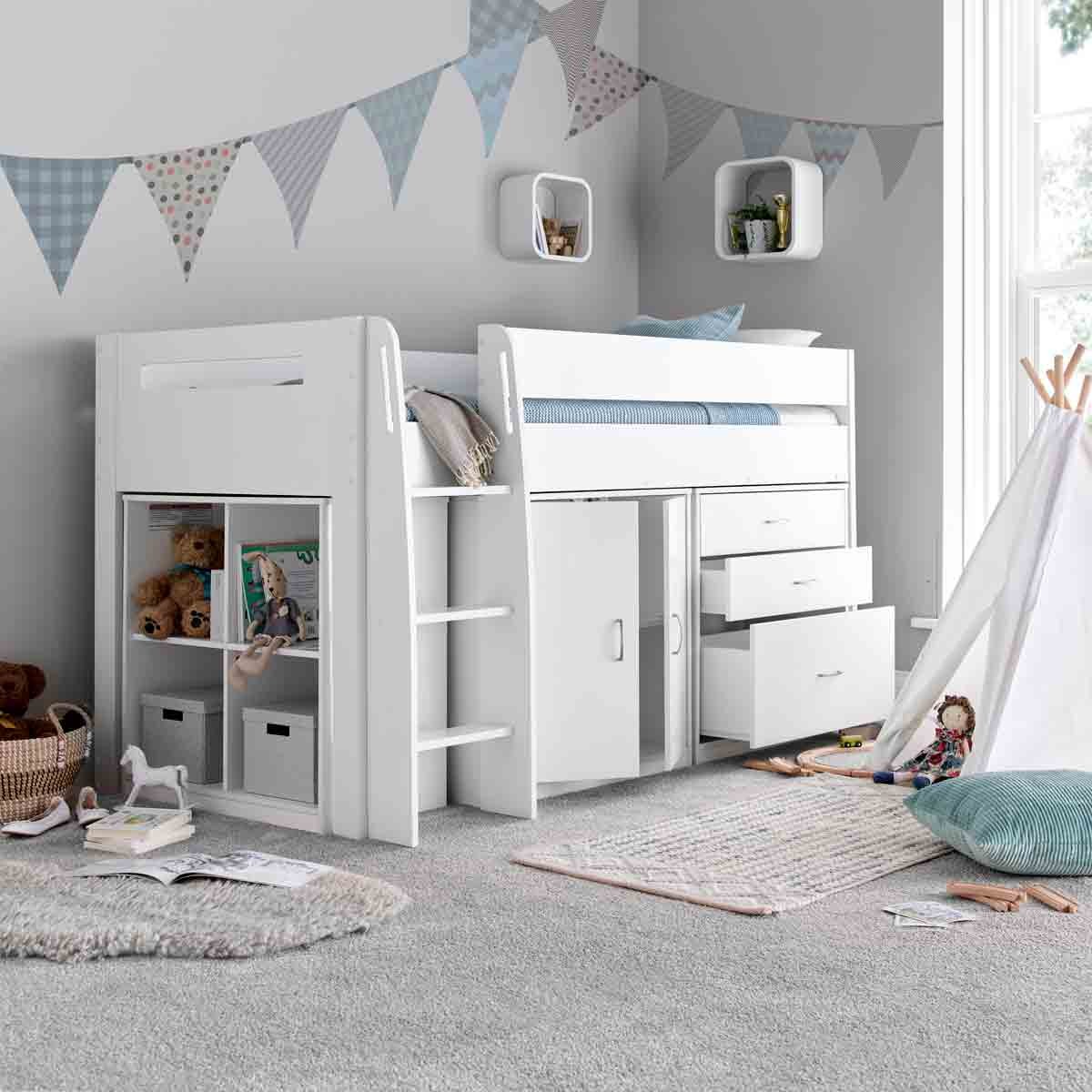 Lacy white mid sleeper bed with storage drawers and shelves, featuring a pocket sprung mattress, set in a cozy room with soft carpet and playful decor.